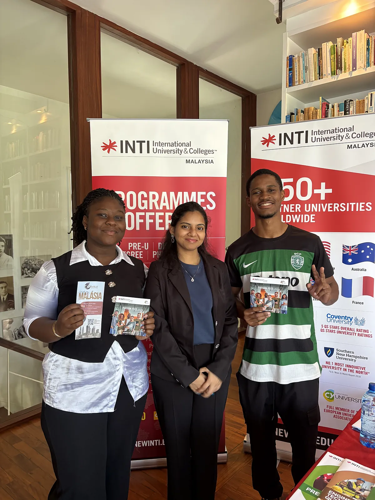Students holding brochures about studying in Malaysia