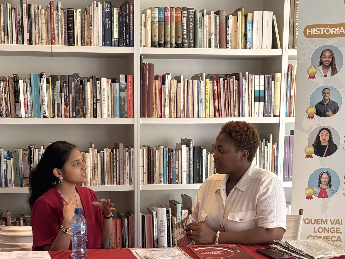 A university representative advising a student at an open day in Maputo